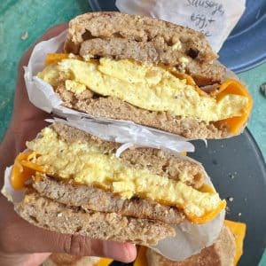 A sausage, egg, and cheese breakfast sandwich cut in half to show the cross section.