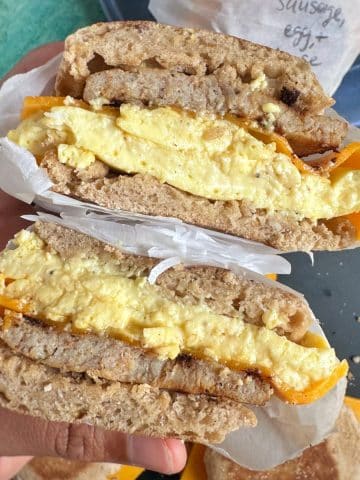 A sausage, egg, and cheese breakfast sandwich cut in half to show the cross section.
