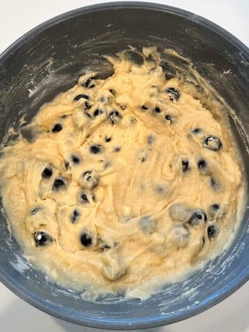 A bowl filled with lemon blueberry cake batter.