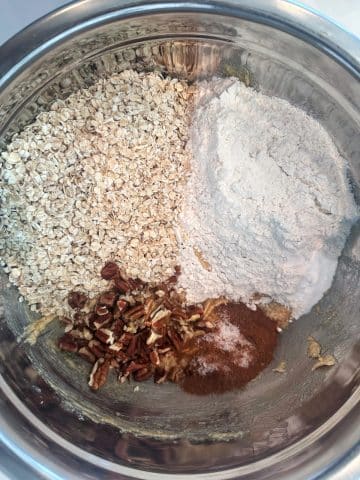 An ingredient shot containing the dry ingredients for oatmeal cookies including oats and flour.