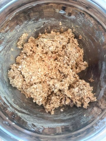 An ingredient shot for chewy oatmeal cookies - a silver bowl containing the finished dough.