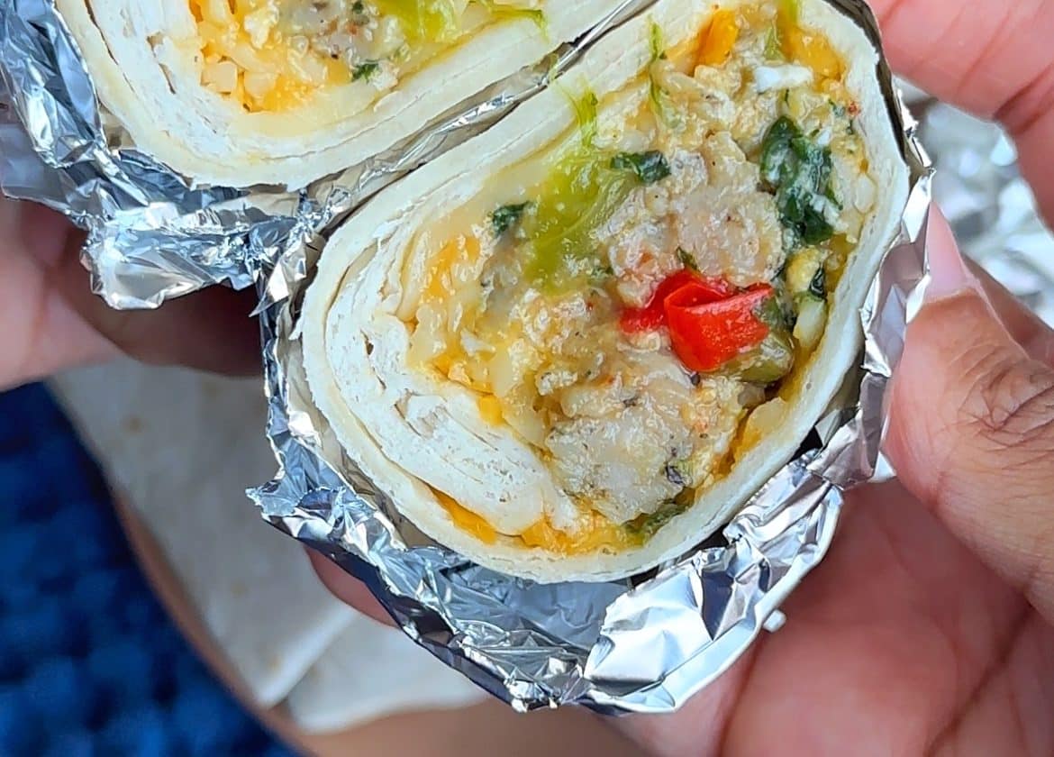 A closeup shot on the inside of a Chicken Sausage, Egg, and Cheese Southwest-Style Burrito.