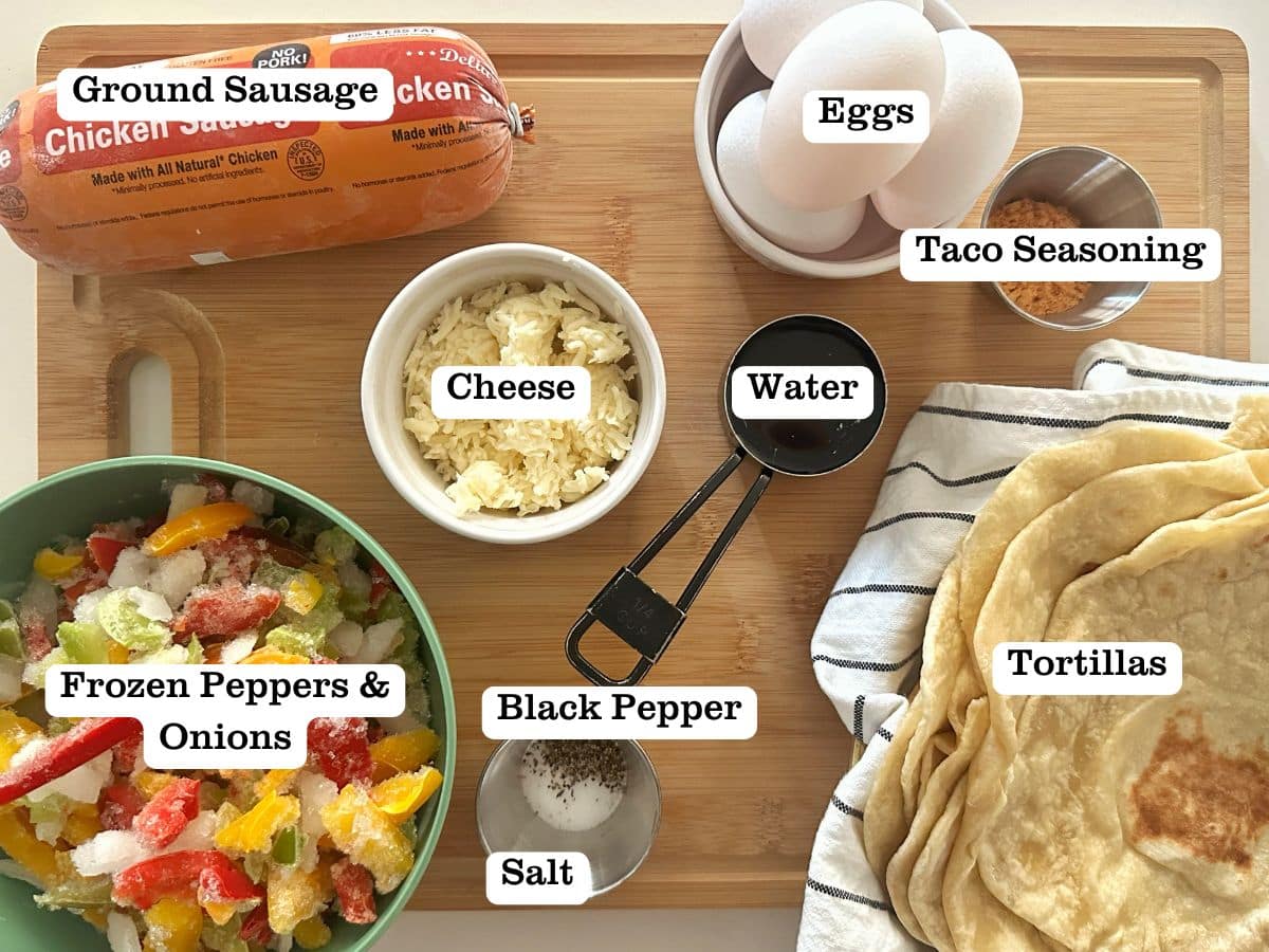 A wooden boar containing ingredients for homemade breakfast burritos, including peppers and onions, cheese, and taco seasoning.