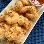 A plate of air fried coconut shrimp.