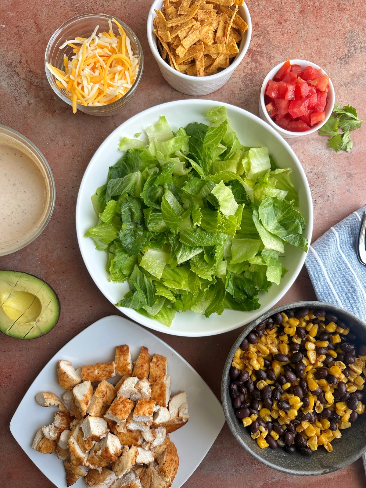 Bowls of prepped ingredients for a taco salad.
