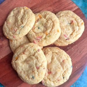 A pile of funfetti cookies made of cake mix on a wooden board.