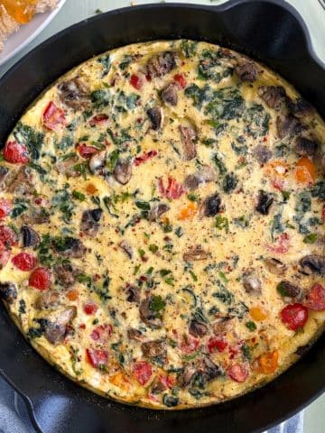 A cast iron filled with a Vegetable Frittata.