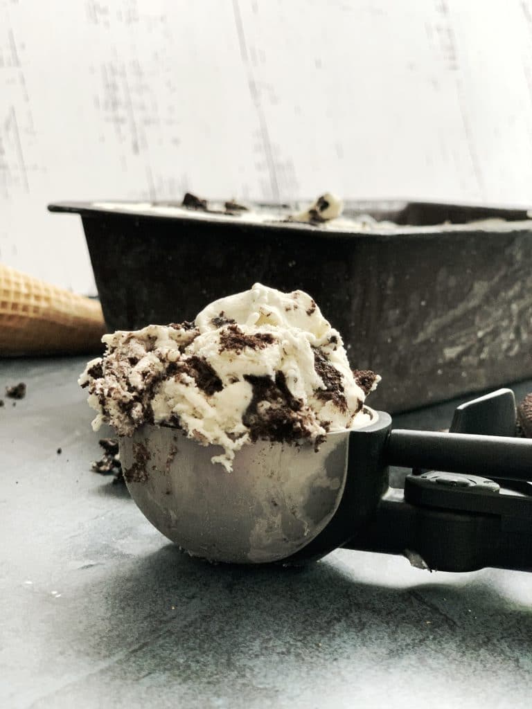 No churn cookies and cream ice cream in a scooper.