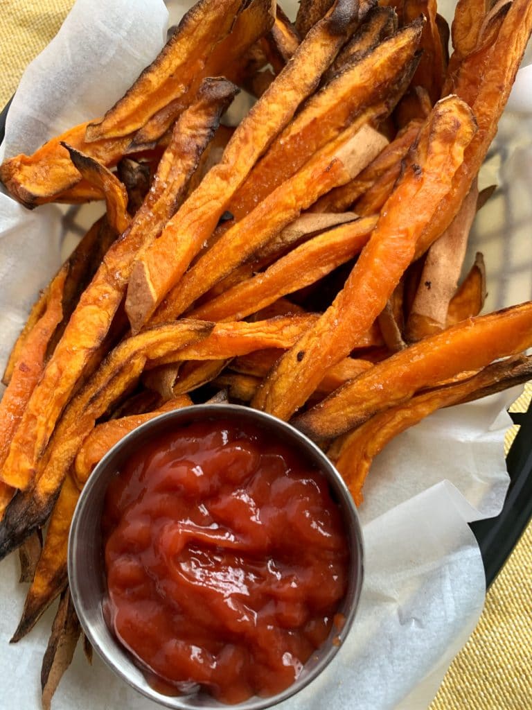 air fried sweet potato fries with ketchup in a small bowl