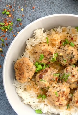 curry turkey meatballs over rice in a grey bowl