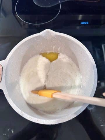 A saucepan with melted butter inside.