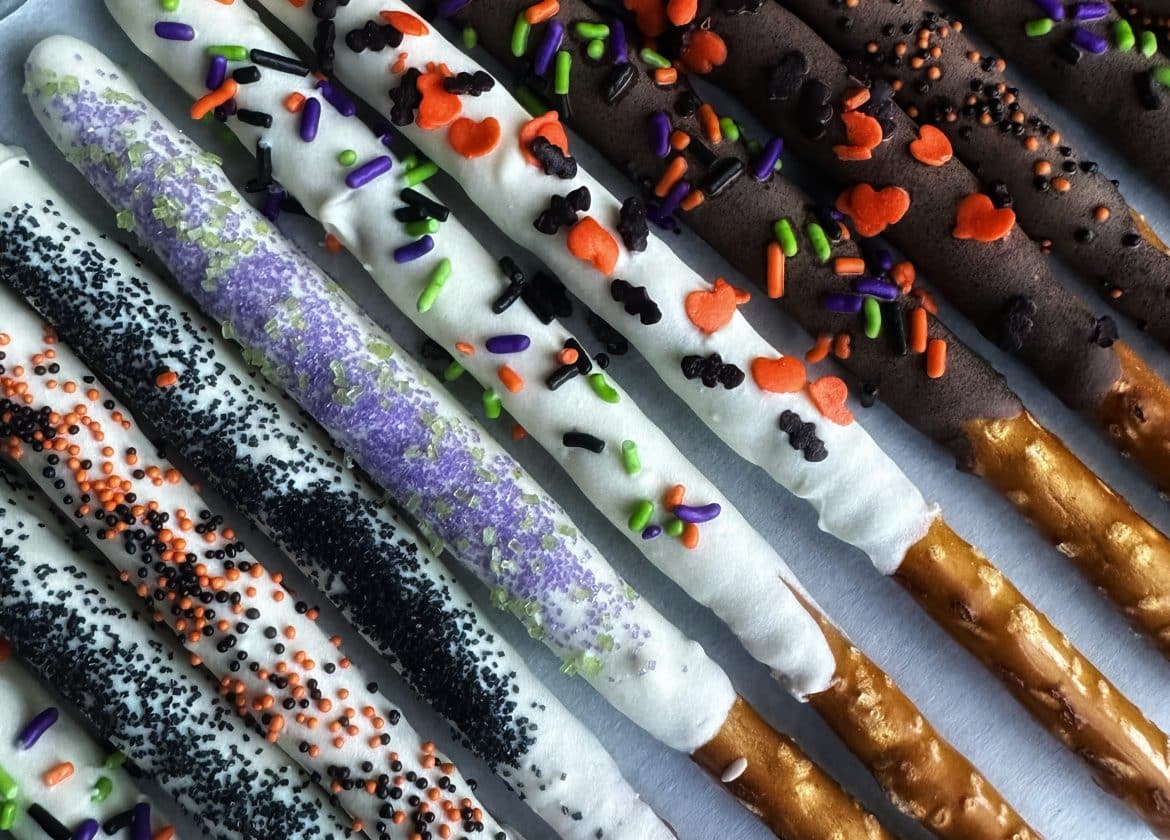A tray of chocolate-covered pretzel rods decorated as "magic wands" for Halloween.