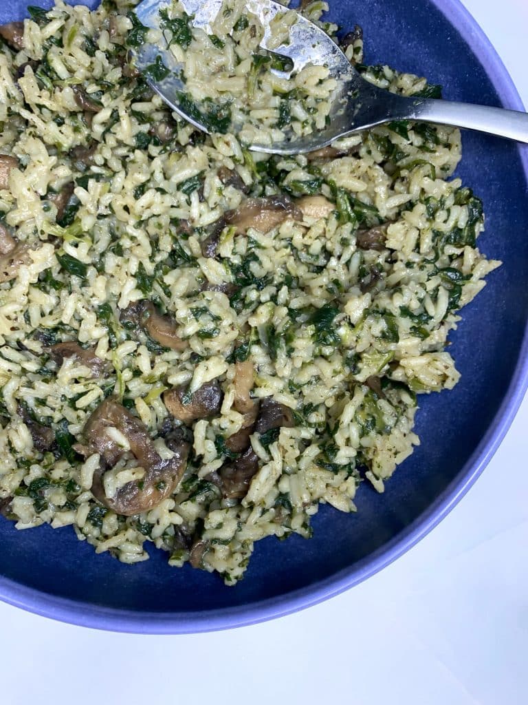 bowl of one-pot creamy mushroom & spinach rice