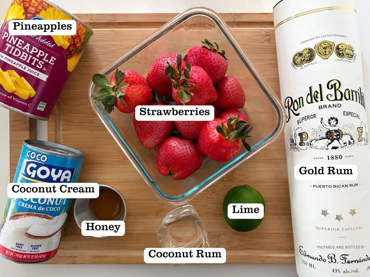 A wooden board with containers of ingredients to make a Miami vice popsicle at home.