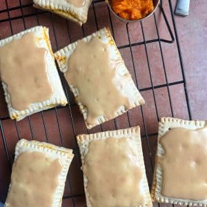 Pumpkin flavored homemade pop tarts on a wire rack.