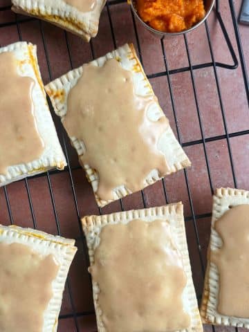 Pumpkin flavored homemade pop tarts on a wire rack.
