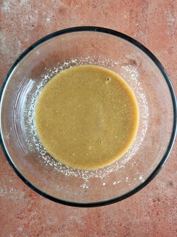 A bowl of lemon juice, Worcestershire, dijon mustard, and anchovy paste whisked together.