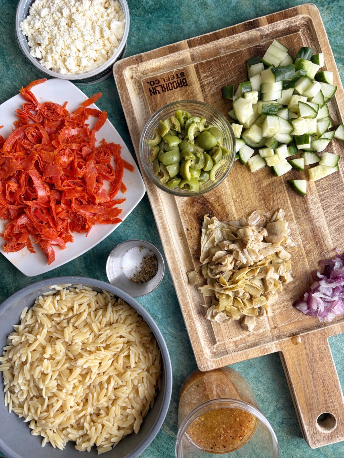 An overhead shot of pasta salad ingredients right before assembly.