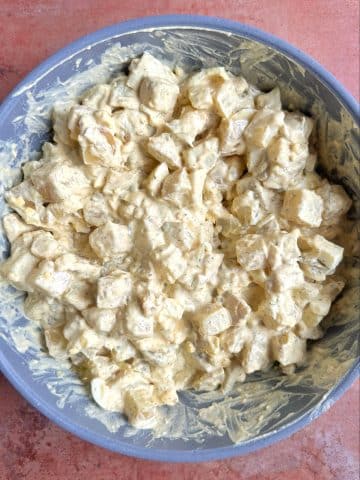 Southern potato salad mixed together in a large grey bowl.