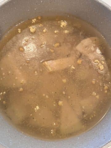 A pot of canned jackfruit boiling in broth.