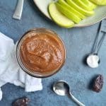 A bowl of date caramel with apple slices on the side.