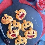 Hand pies shaped like pumpkins, with jack-o-lantern faces cut out of the top, and filled with jam.