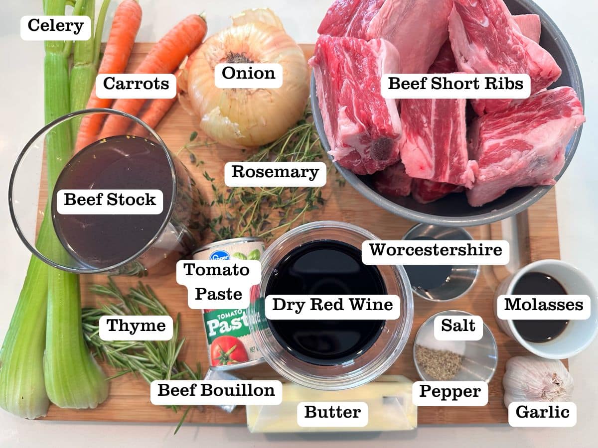 A wooden board containing ingredients for braised short ribs.