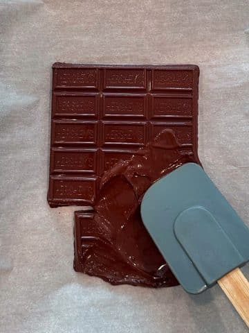 A silicone spatula spreading out melted chocolate.