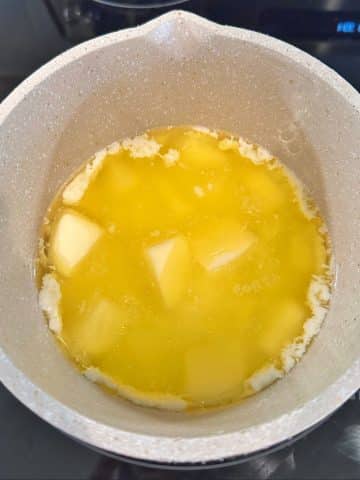 A saucepan filled with melted butter.