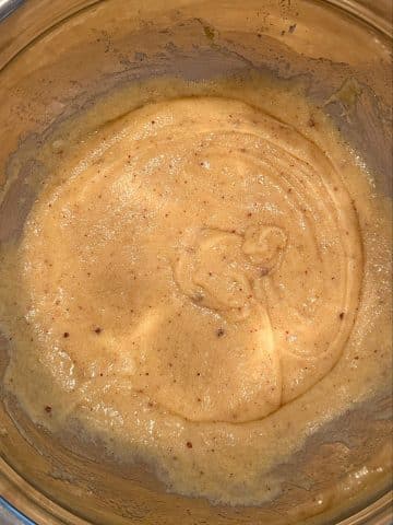 A mixing bowl filled with cookie batter before adding the flour and other dry ingredients.