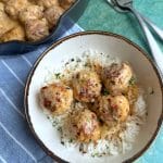 A bowl of Curry Turkey Meatballs served over rice.