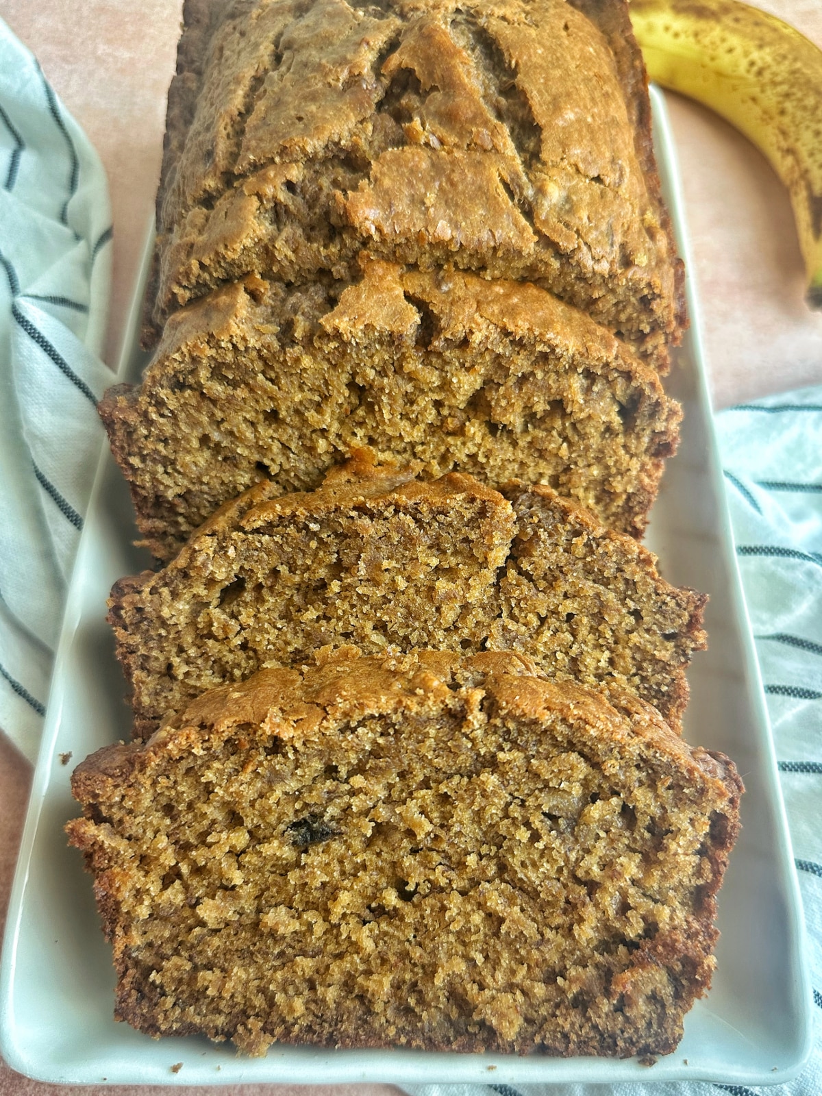 A sliced loaf of espresso banana bread on a serving tray.