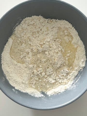 A bowl filled with flour, melted butter, and hot water.