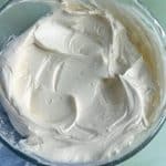 A bowl of homemade white buttercream with medium peaks.