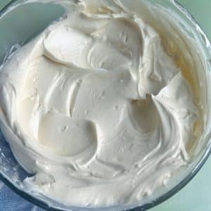 A bowl of homemade white buttercream with medium peaks.