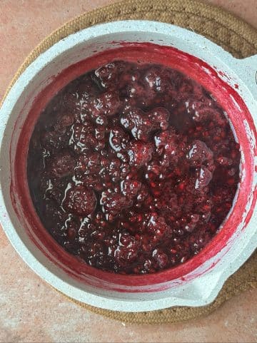 A pot of boiling blackberries in their own juice.