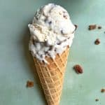 A waffle cone filled with homemade butter pecan praline ice cream.