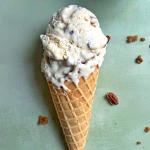 A waffle cone filled with homemade butter pecan praline ice cream.
