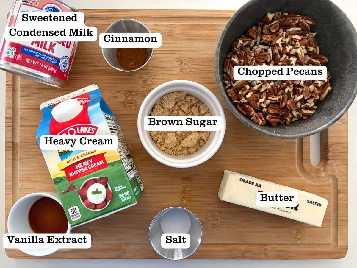A wooden board with containers of ingredients to make butter pecan praline ice cream.