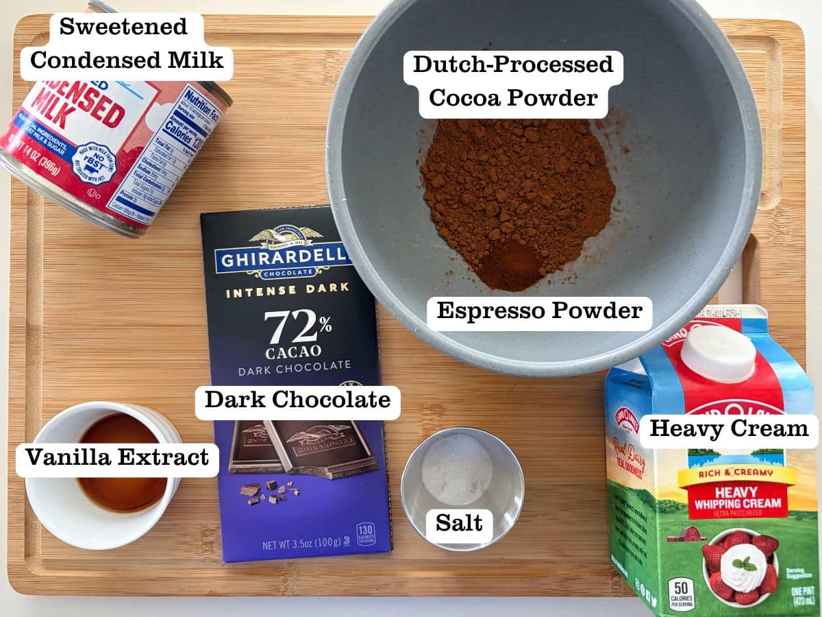 A wooden board with containers of ingredients for homemade dark chocolate ice cream.