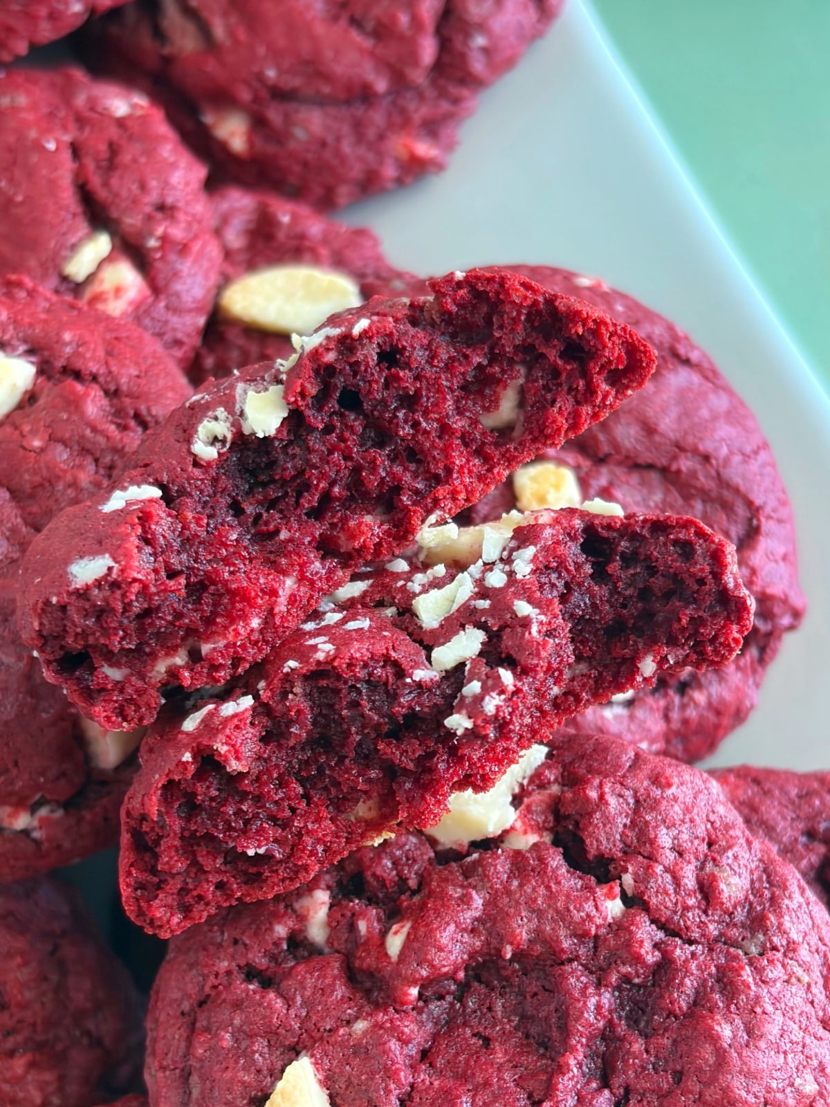 A texture shot of a red velvet cookie cut in half.