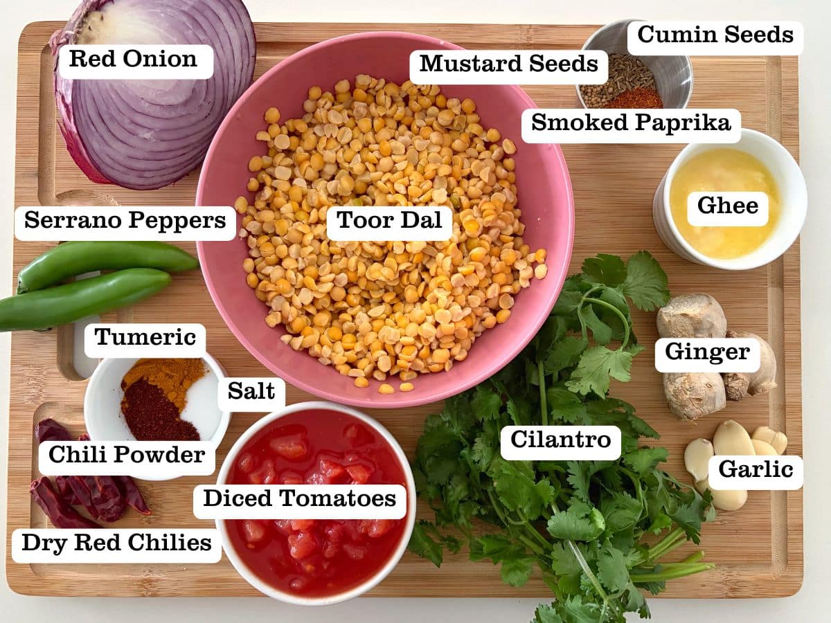 A board with containers of ingredients to make Dal Tadka, an Indian curry.