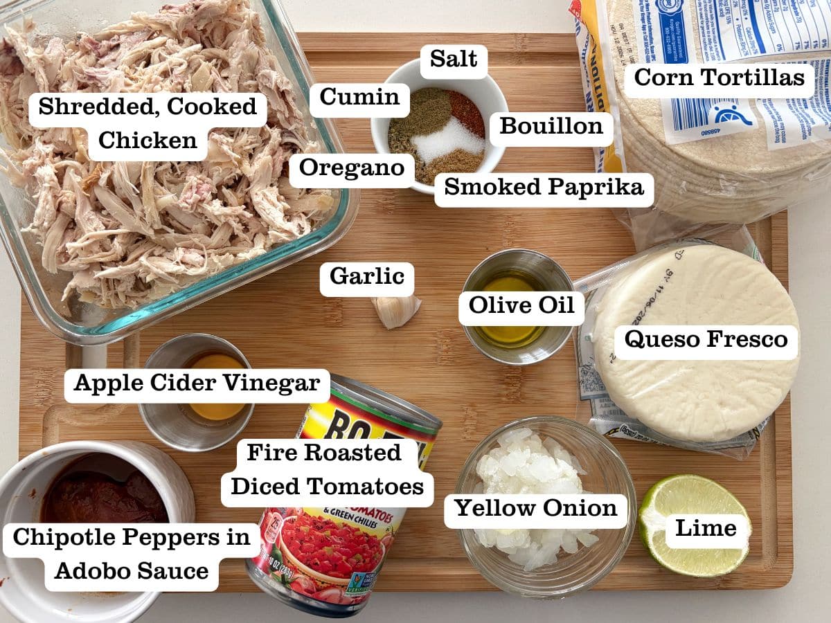 A board with containers of ingredients used to make chicken taquitos.